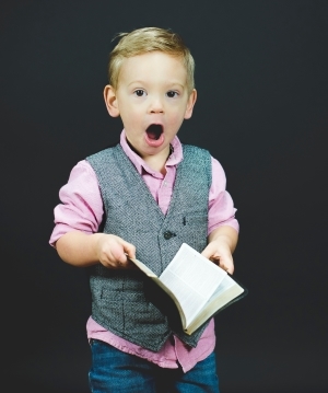 Picture of a boy amazed by reading the Bible