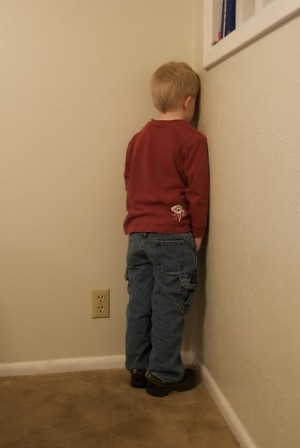 A picture of a child disciplined in time out.