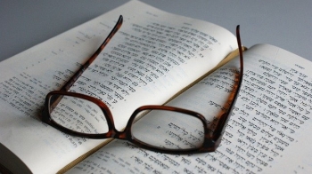 Picture of glasses on an open Bible, which God has given so that we can know that He is the Lord.